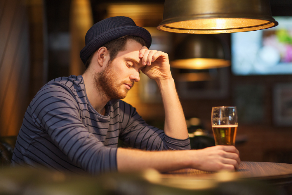 Man self-medicating with beer and alcohol